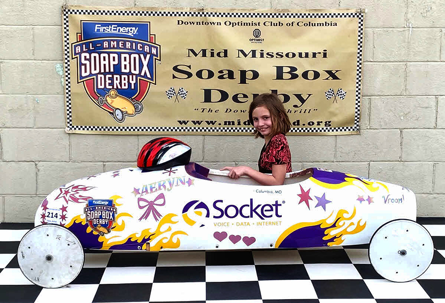 Aeryn Davis sits with the Socket Derby Car, which she decorated for this years Derby race.