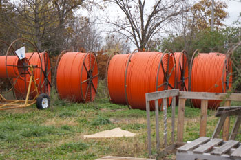 four orange reels of fiber