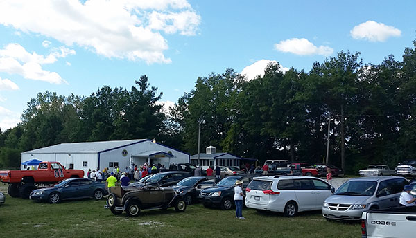 People gather near a parking lot in preparation for the Millersburg Celebration