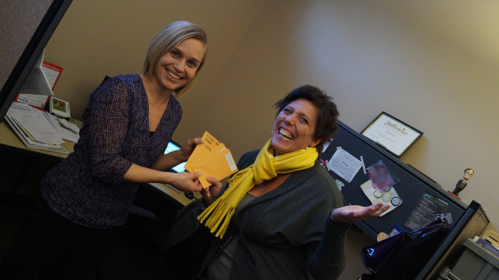 The winner of True False Tickets smiles as she receives her tickets